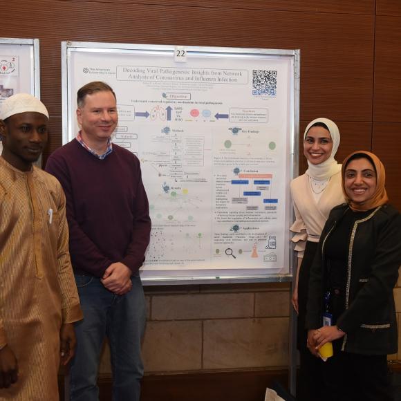 Males and females are standing and smiling