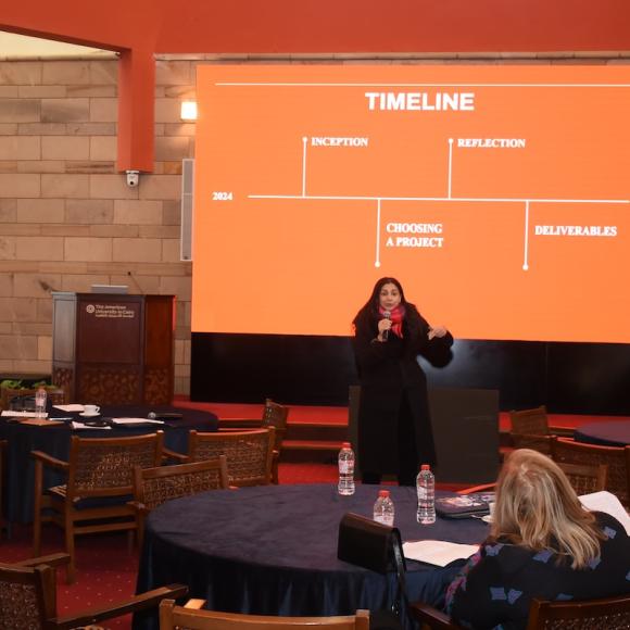 A female talking in a microphone.