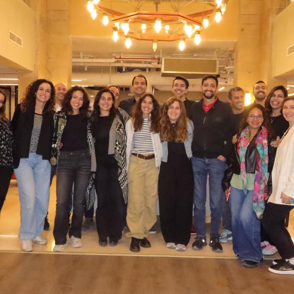 a group photo of men and women taken at a prestigious event or ceremony