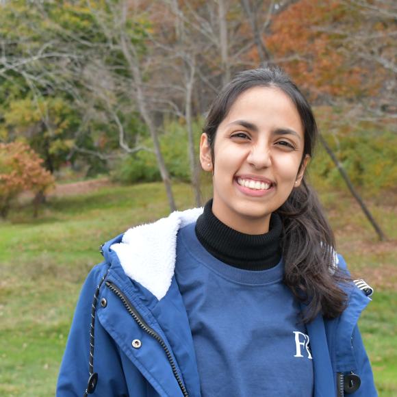 Husn at an open forrest smiling to the camera