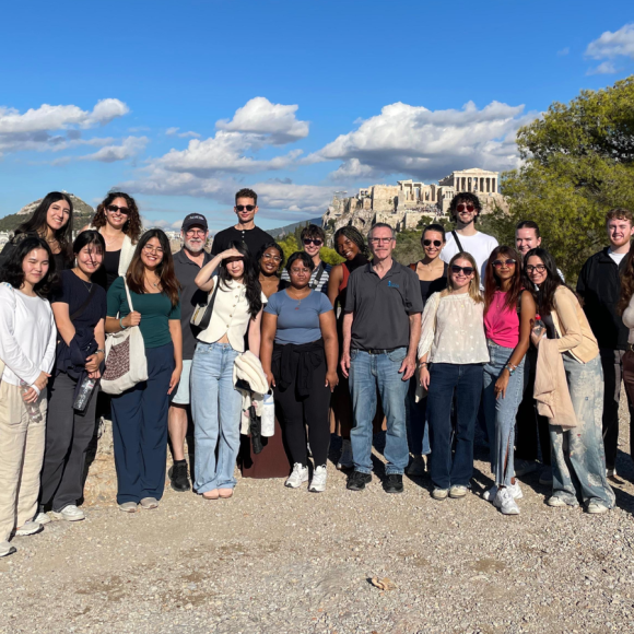 A group photo of students on a hill in Greece