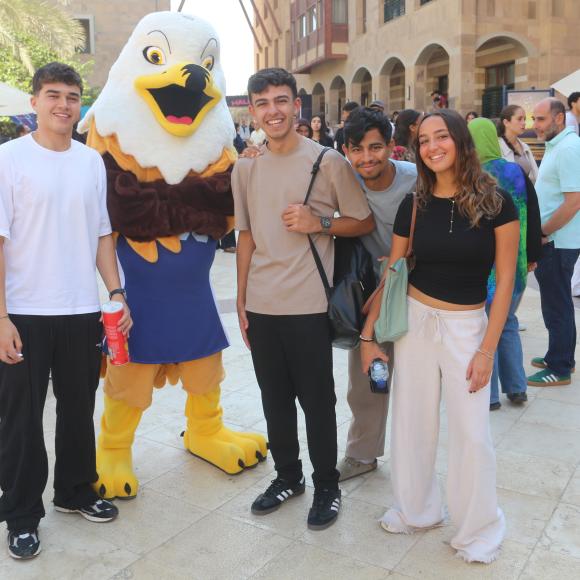 auc students taking a photo with the mascot