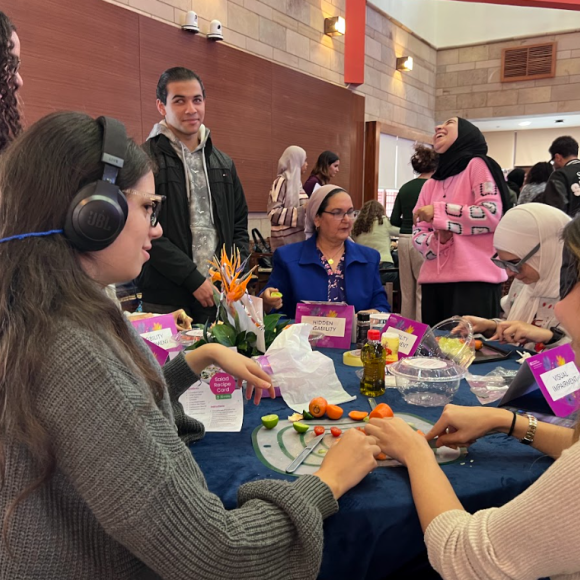 Students with simulated audio and visual impairments helping each other