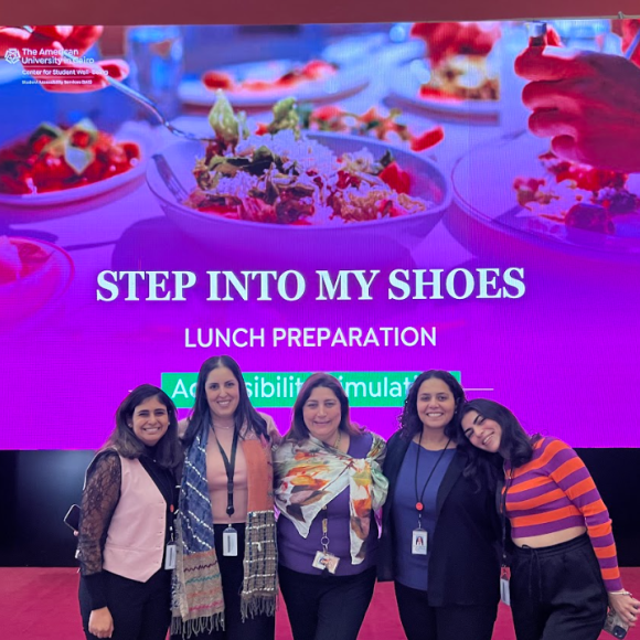 Organizers posing in front of "step into my shoes" banner