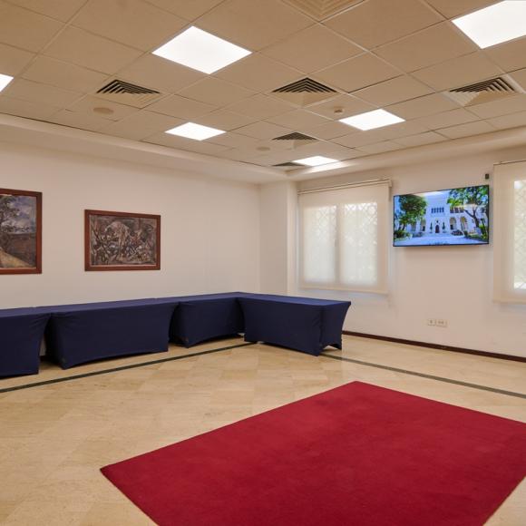 An empty room with tables at the side