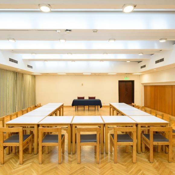 A room that has tables displayed together in rectangle